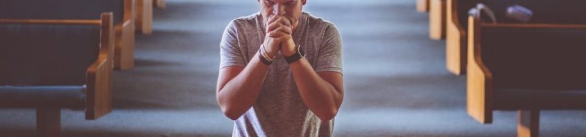 A man praying at church.