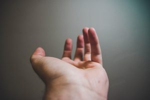 An outstretched hand with palm facing upwards