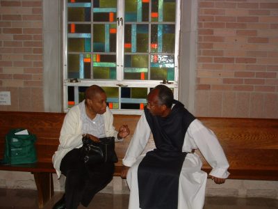 A monk speaking with a Lay Cistercians member.