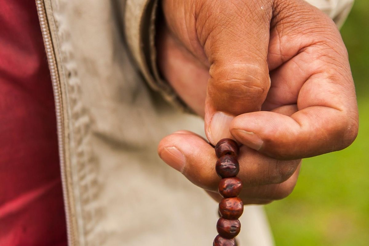 A person praying the rosary. Monastic practices for everyone.
