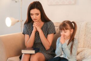 A mother teaching her daughter how to pray is one sign that she is a spiritual mother.