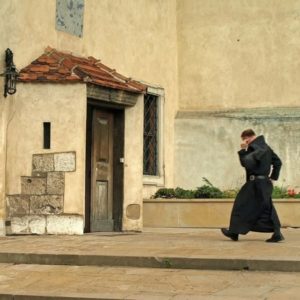 A Benedictine monk heading towards a chapel.