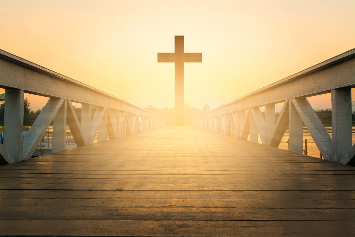 A Christian cross at the end of a walkway.