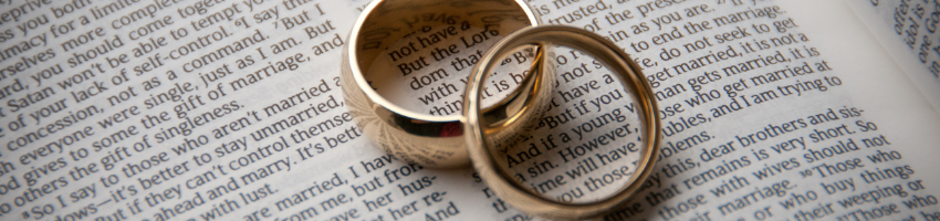 Newlyweds couple placed their wedding rings on the bible verses