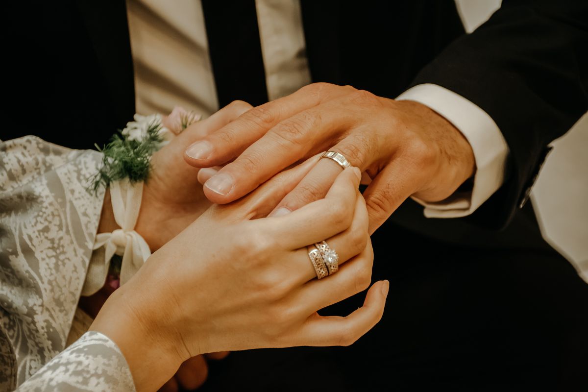 Couple holding their hands together and reading the bible verses for the newlyweds