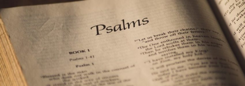An open bible showing encouraging Psalm verses.