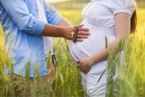 A pregnant couple excitedly waiting for the "fruits of the womb."