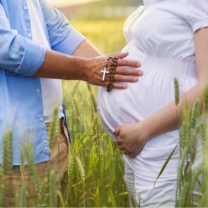 A pregnant couple excitedly waiting for the "fruits of the womb."