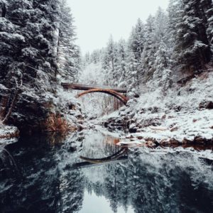 A bridge spanning across a frozen river.