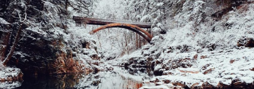 A bridge spanning across a frozen river.