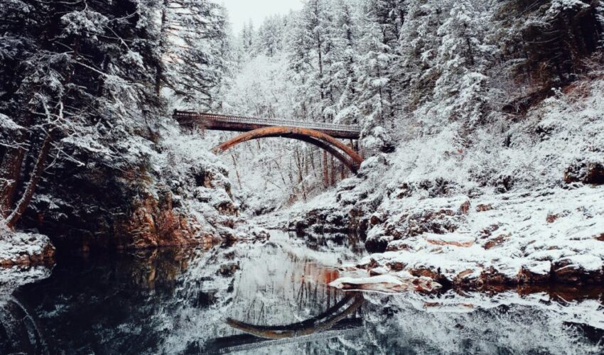 A bridge spanning across a frozen river.