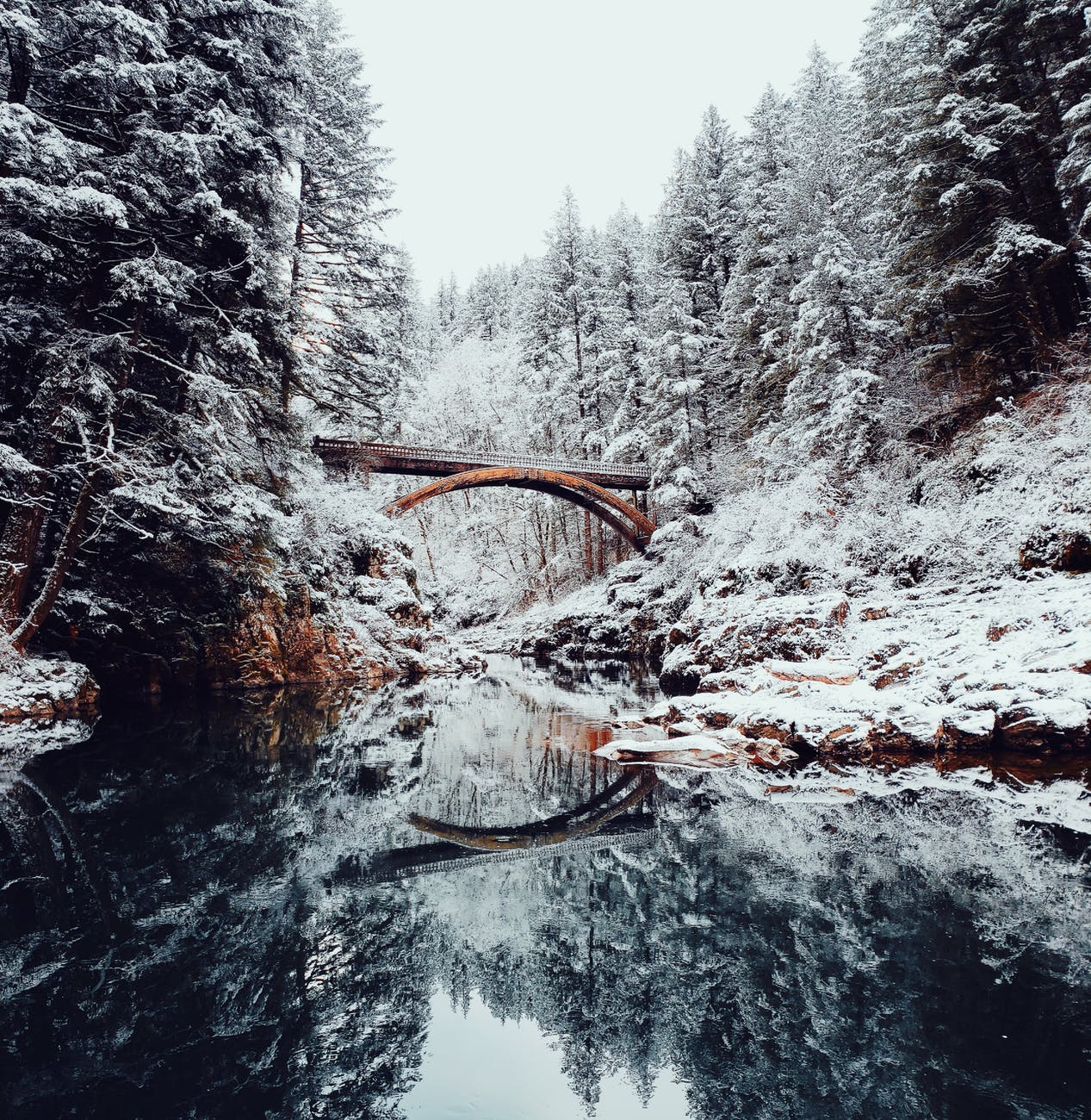 A bridge spanning across a frozen river.