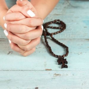 A woman praying to St. Anne.