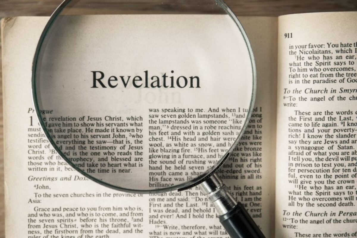 A photo of a bible with magnified revelation bible verses.
