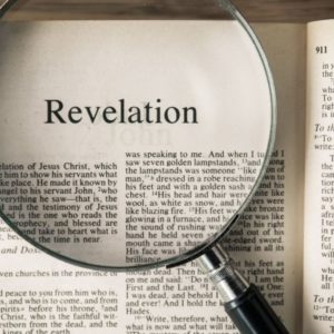 A photo of a bible with magnified revelation bible verses.