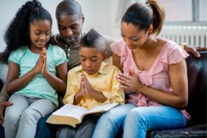 A family praying together for the night.