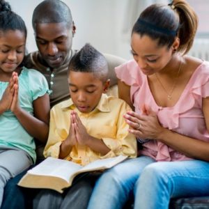 A family praying together for the night.