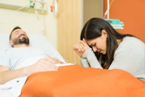 A woman praying for her husband's healing.