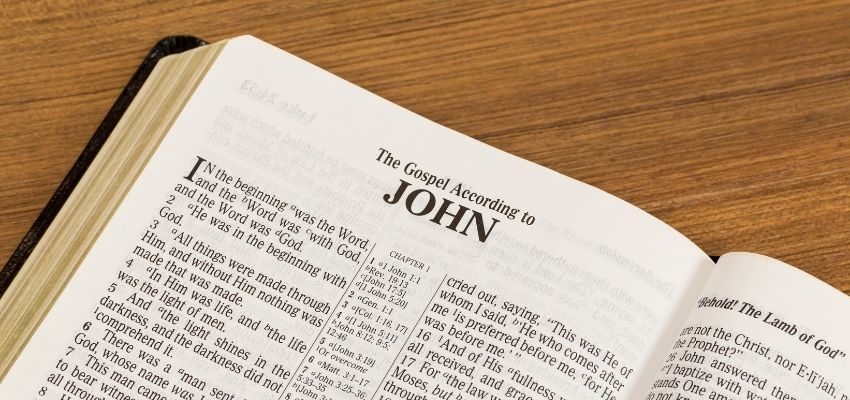 An open bible showing verses from the Gospel of John.