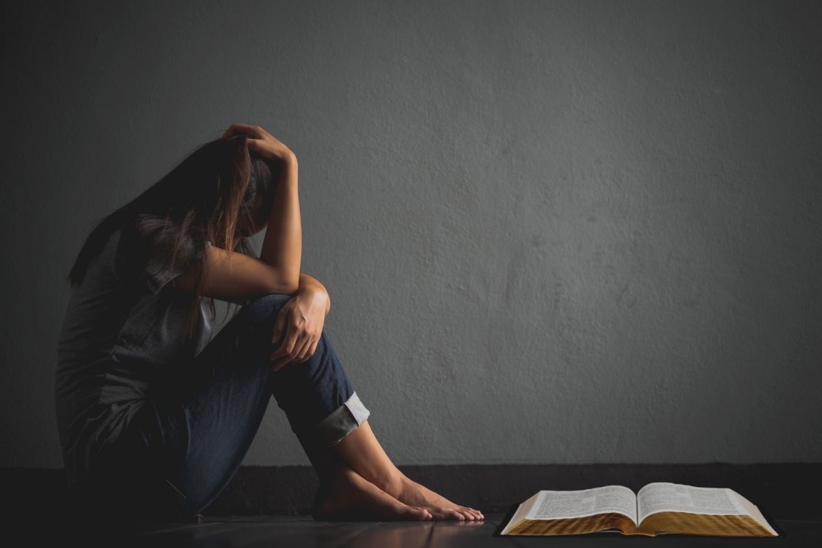 A woman looking at bible verses for the weary.