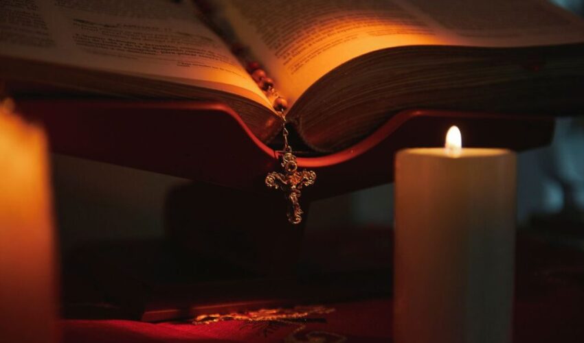 A man kneeling in front of the cross as a sign of repentance for the mortal sins he has committed.