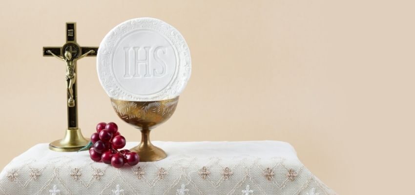 The Eucharist with the cross behind it.