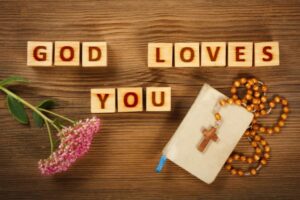 Wooden letter blocks arranged to spell "God Loves You".