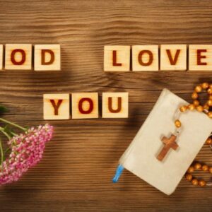 Wooden letter blocks arranged to spell "God Loves You".