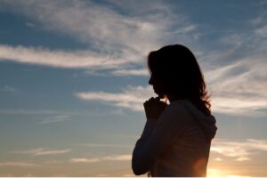 A woman prays a catholic birthday prayer for herself.