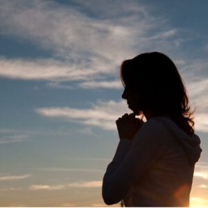 A woman prays a catholic birthday prayer for herself.