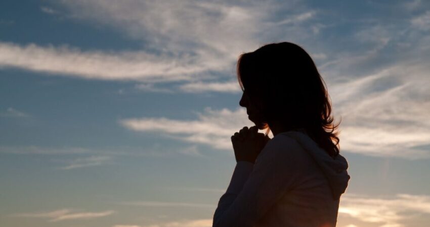 A woman prays a catholic birthday prayer for herself.