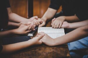 A group of people reads Psalms of bible verses to get some encouragement.