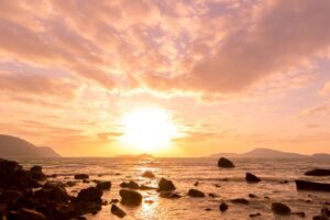 A view of the sunset on the beach.