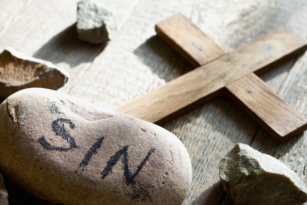 The woven crown of thorns and a bloody cross symbolize the sacrifice of god. 