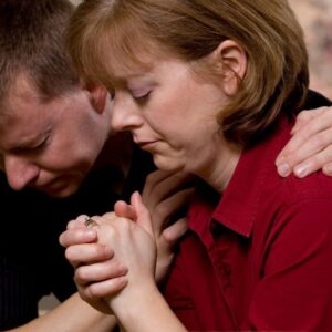 Couple praying fertility prayer together.