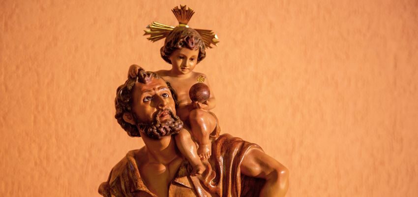 Saint Christopher often shown as a tall figure carrying the Christ child over a river, this image signifies his portrayal as the patron saint of travelers.