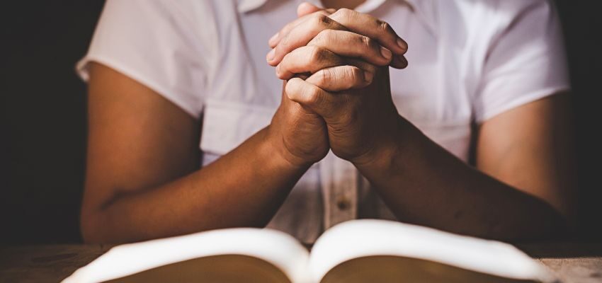 The sailing crew prays to the patron saint of sailors for protection, seeking spiritual support to navigate the dangers of the sea.