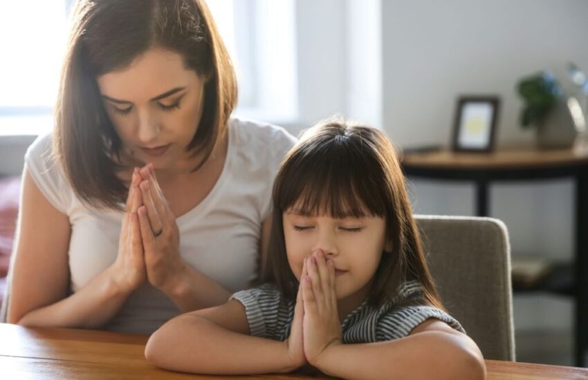 A mother and daughter are praying for healthy body. 