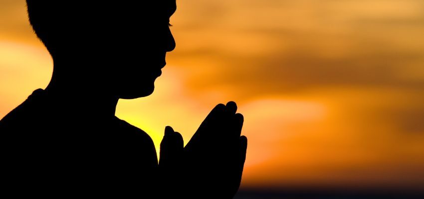 The man is praying for the dead.