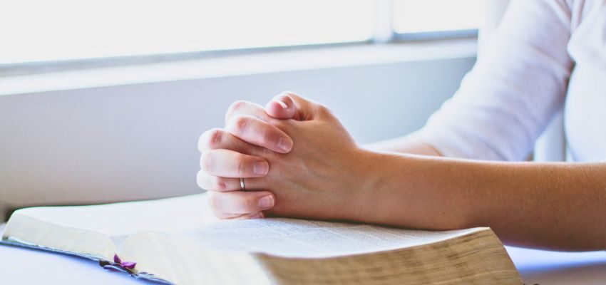 The woman is praying for the dead.
