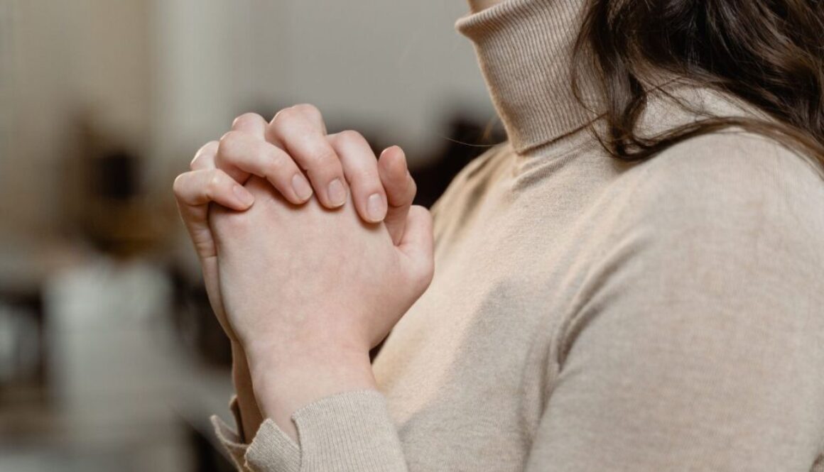 A Christian mother is praying for her unborn baby.