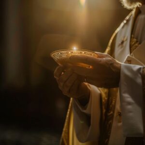 A priest holding the Eucharist during mass.