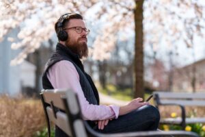 The man is listening to one of the famous Christian podcasts on Spotify.