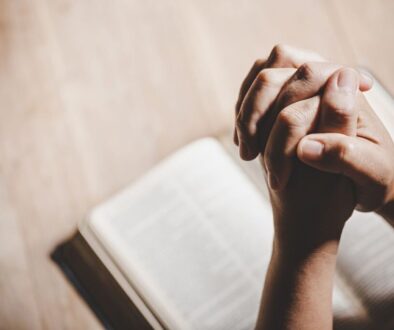 The person is praying to St. Lucy after reading a bible.