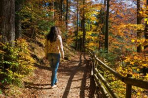 The woman is doing a prayer walk while surrounded by nature.