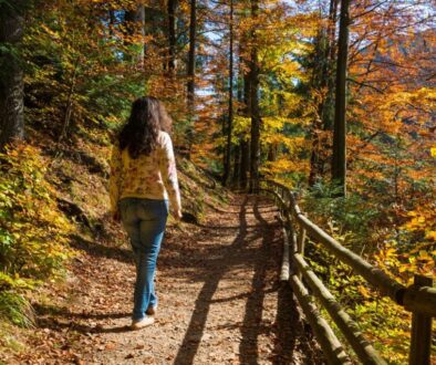 The woman is doing a prayer walk while surrounded by nature.