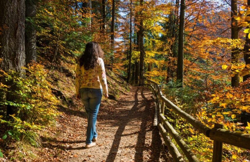 The woman is doing a prayer walk while surrounded by nature.