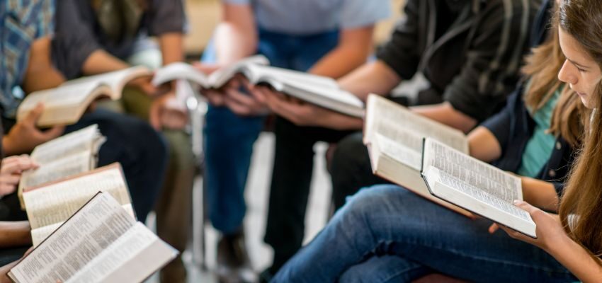 The group of people do bible studies together.