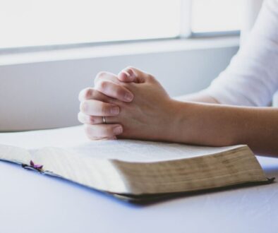 The woman is praying after reading bible verses.