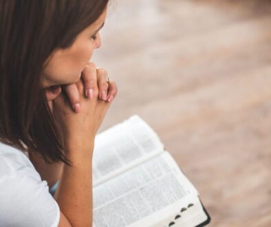 The woman solemnly prays every morning.